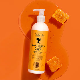 Camille Rose cream on hand demonstrating slip for easier styling