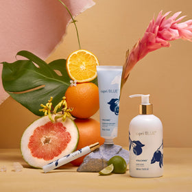 Capri Blue Volcano tube in a handbag illustrating portability and on-the-go moisturizing benefit