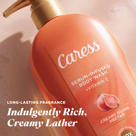 Caress bottle held in hand to show 20 fl oz scale and convenient pump size for showers