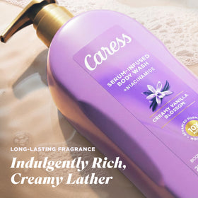 Person using Caress body wash in shower showcasing indulgent clean and soft skin benefit