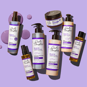 Carol's Daughter applied to curly hair to show detangling benefit