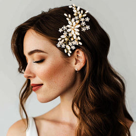 Catery comb on bride in wedding setting enhancing hairstyle with luminous accent