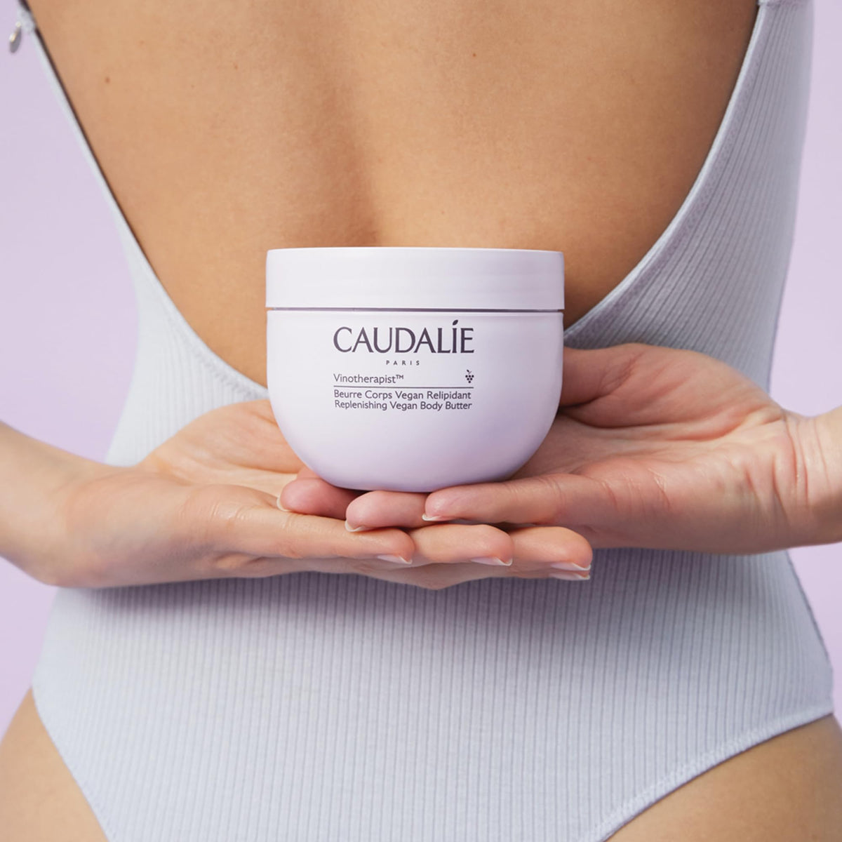 Caudalie jar styled on bathroom shelf, lifestyle scene suggests daily ritual