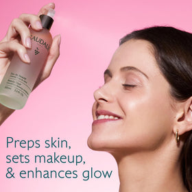 Caudalie mist spraying closeup demonstrating fine even hydration benefit