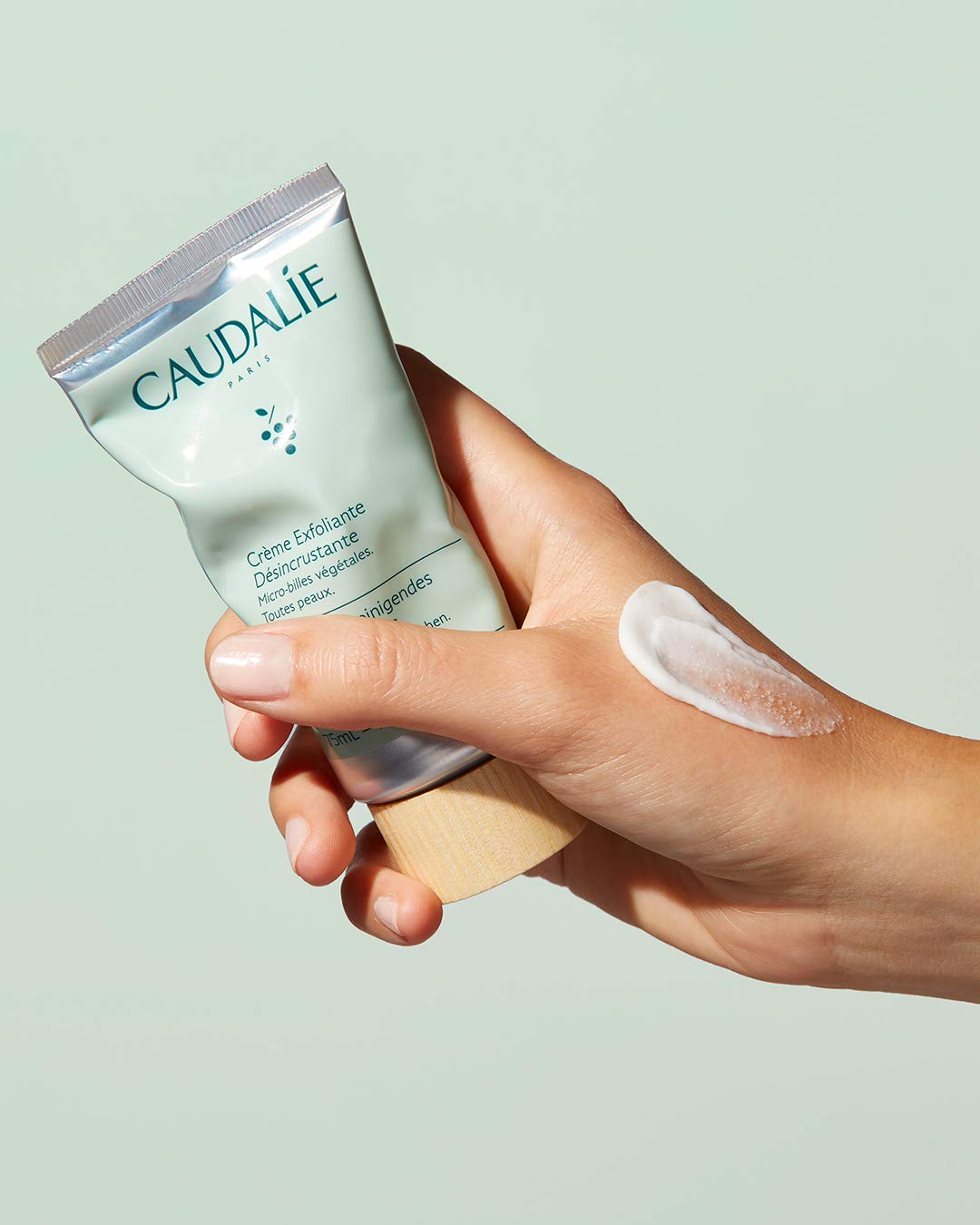 Caudalie in-hand application showing product lather on skin for refreshing cleanse benefit