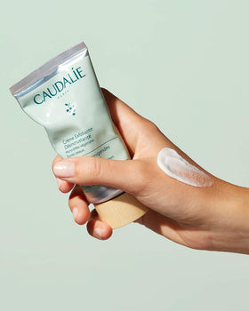 Caudalie in-hand application showing product lather on skin for refreshing cleanse benefit