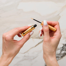 Cellmetics Beauty tube held in hand to show compact size and travel-friendly benefit