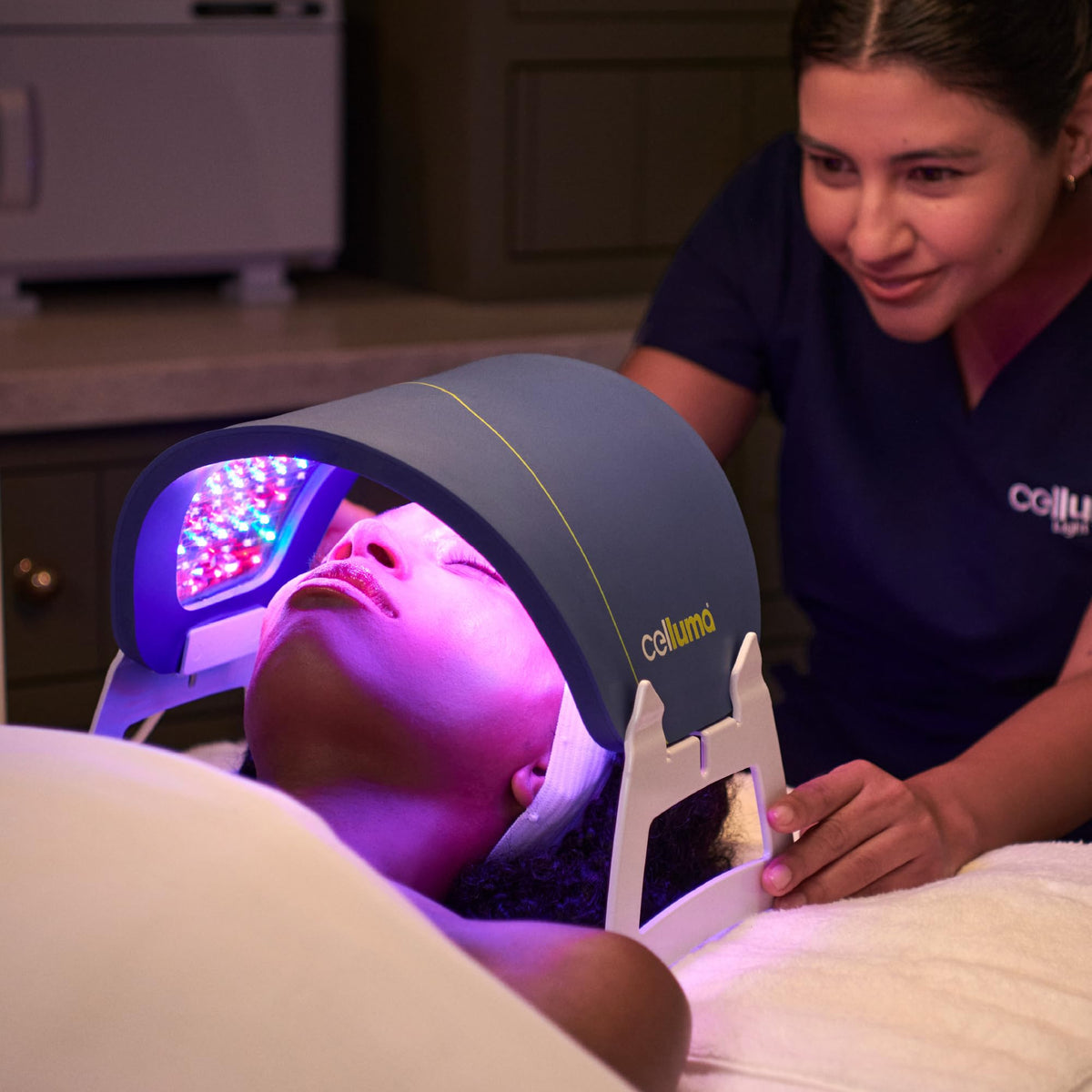 Celluma facial rests next to ruler showing scale and portability benefit
