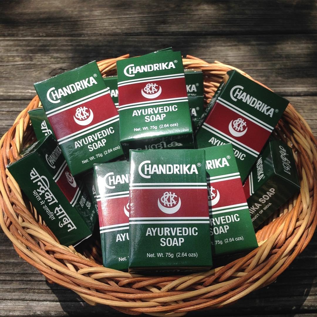 Chandrika bar in hand to show true 75 g size and easy travel-friendly convenience
