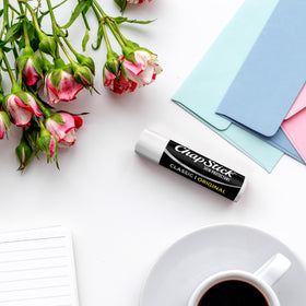 All 24 ChapStick Classic Original tubes spread out to show quantity and value