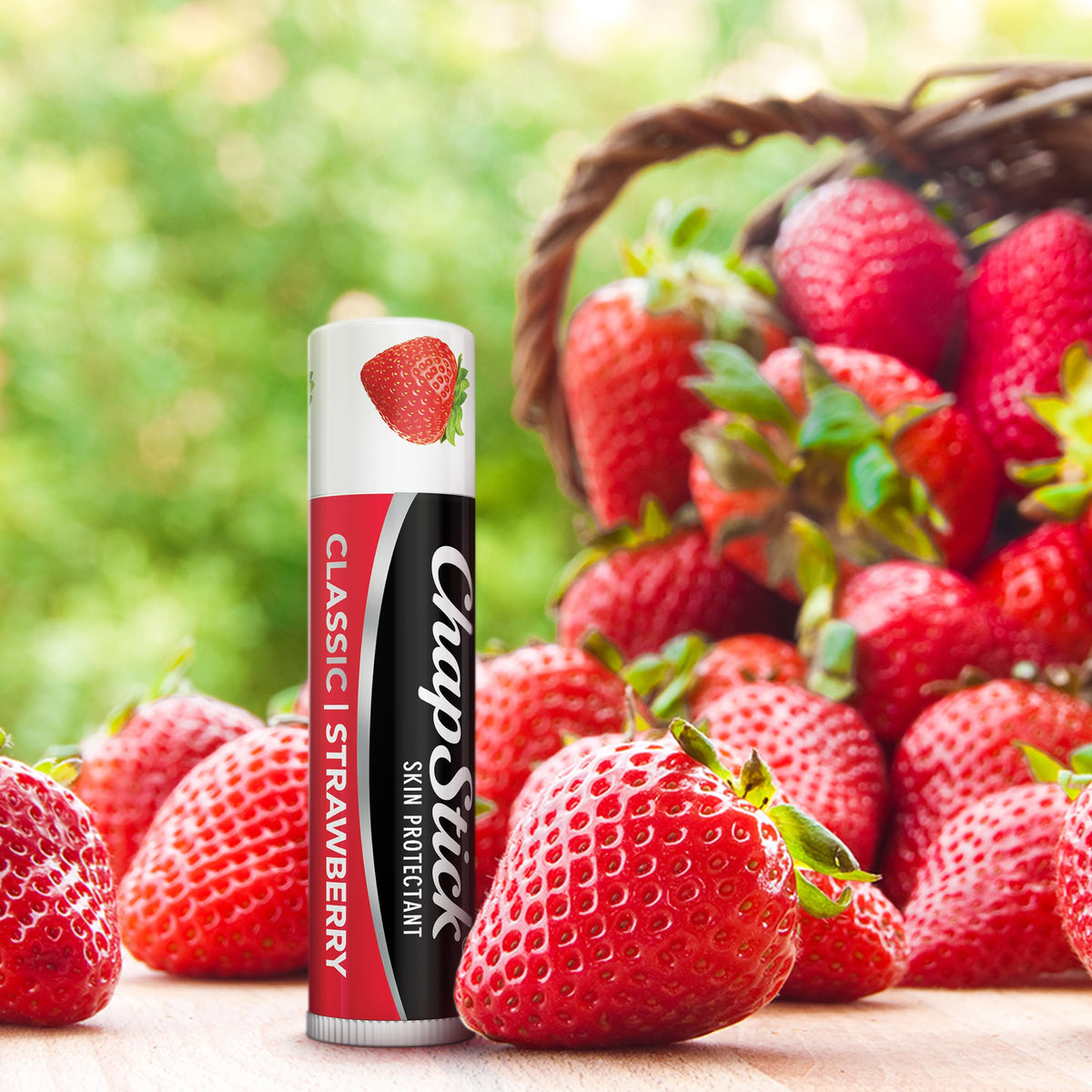 ChapStick Classic strawberry open tube being applied for immediate hydration