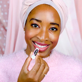ChapStick tube in hand showing size and portability of Cotton Candy