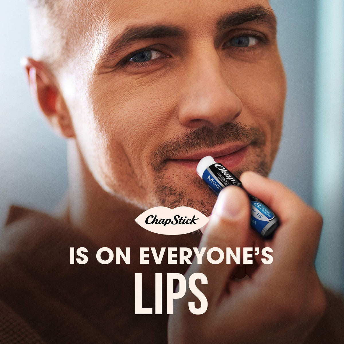 Hand holding ChapStick tube showing scale and easy portability benefit