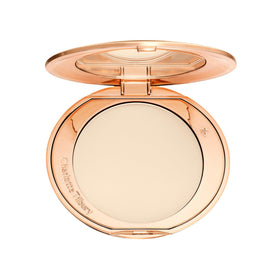 Charlotte Tilbury compact front showing sleek packaging and travel-ready design benefit