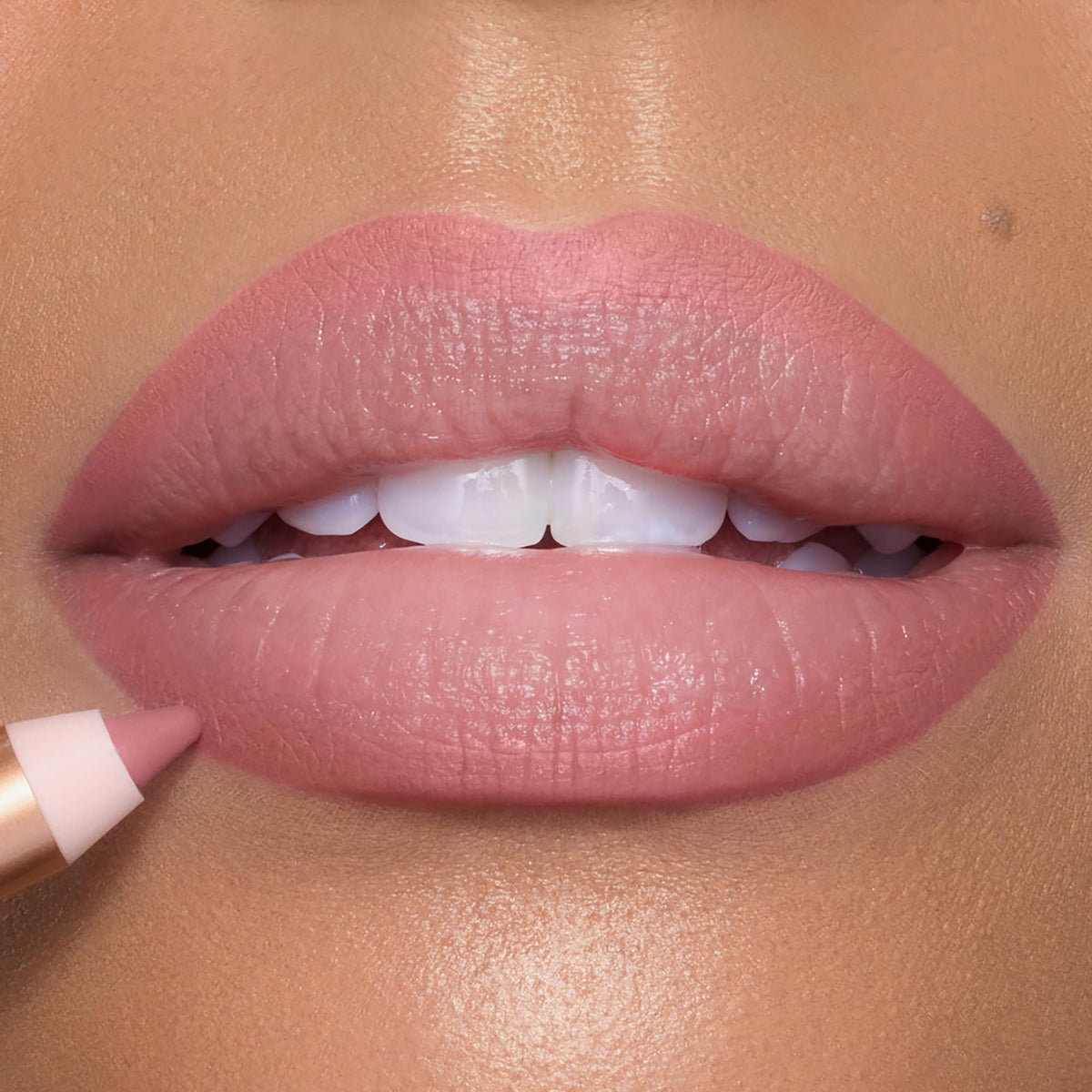 Charlotte Tilbury applying pencil to lips mid-application showing control and easy shaping benefit