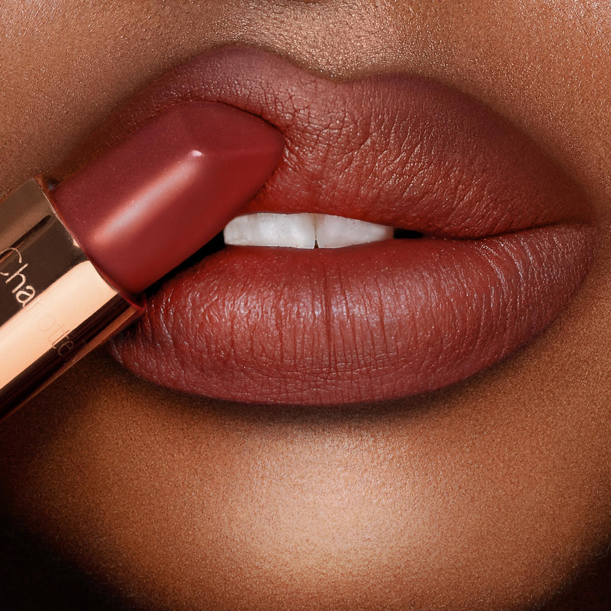 Charlotte Tilbury demonstrating square-angled tip for defined lip lines