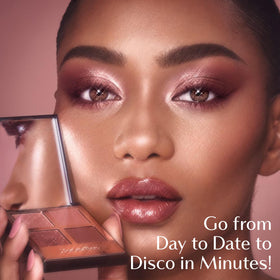 Charlotte Tilbury applying the light shade to prime lids for longer wear and even base benefit