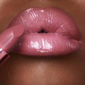 Charlotte Tilbury applied on model smiling in lifestyle shot to demonstrate flattering wearable color
