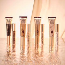 Charlotte Tilbury bottle in hand for size comparison showing travel-friendly benefit