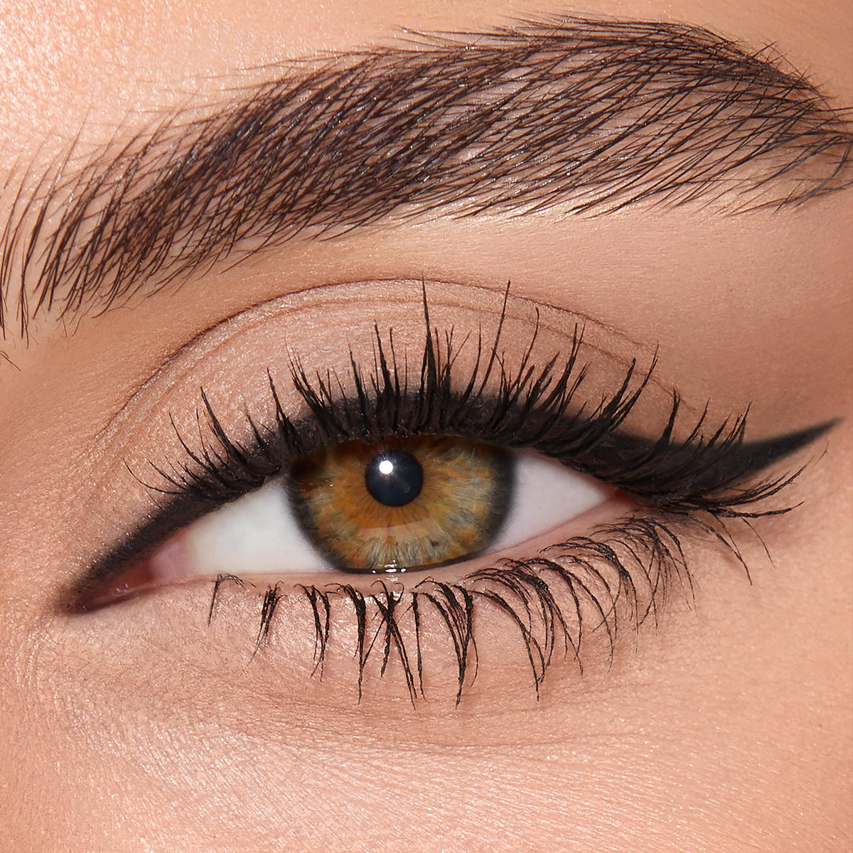 Charlotte Tilbury texture swatch on skin showing rich black payoff
