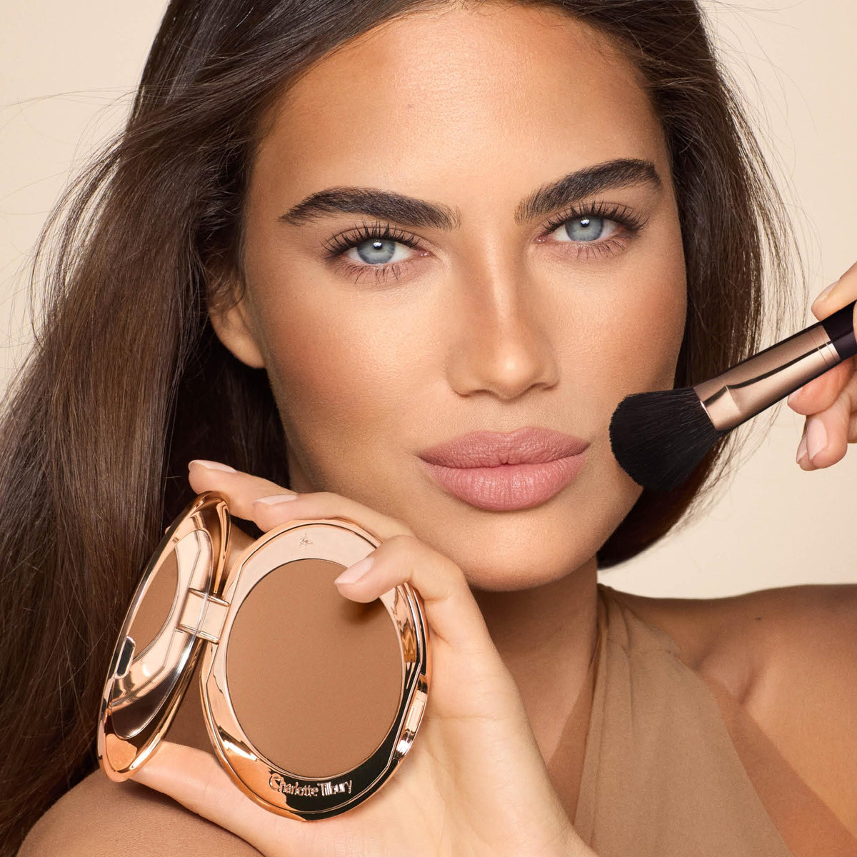 Charlotte Tilbury bronzer pan close-up showing silky texture for smooth skin finish