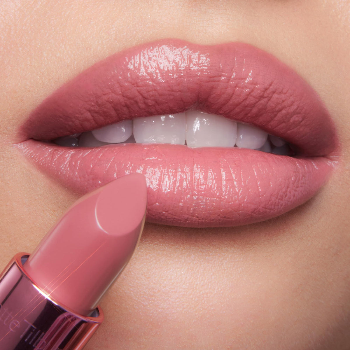 Charlotte Tilbury lipstick texture swatch on skin highlighting satin glow and buildable color payoff