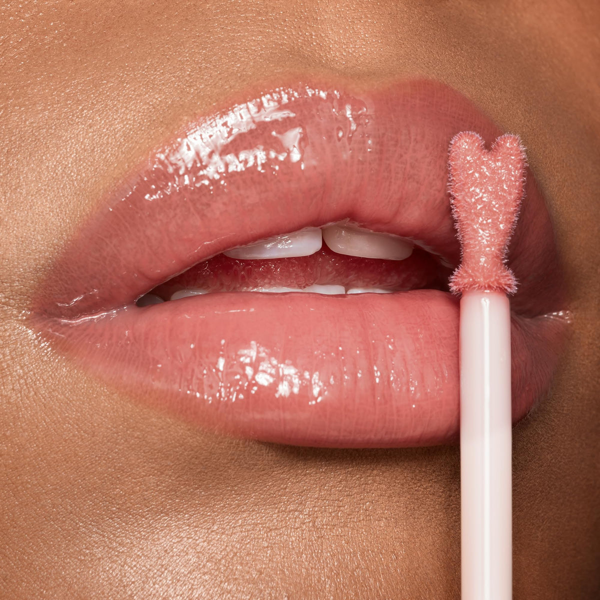 Charlotte Tilbury swatch on arm showing Pillow Talk nude-pink shade and buildable color