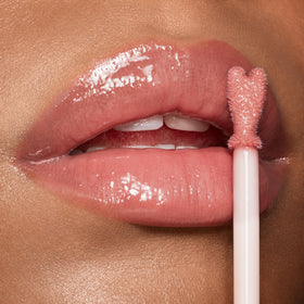Charlotte Tilbury swatch on arm showing Pillow Talk nude-pink shade and buildable color