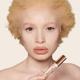 Charlotte Tilbury concealer swatch fair showing sheer radiant coverage on skin
