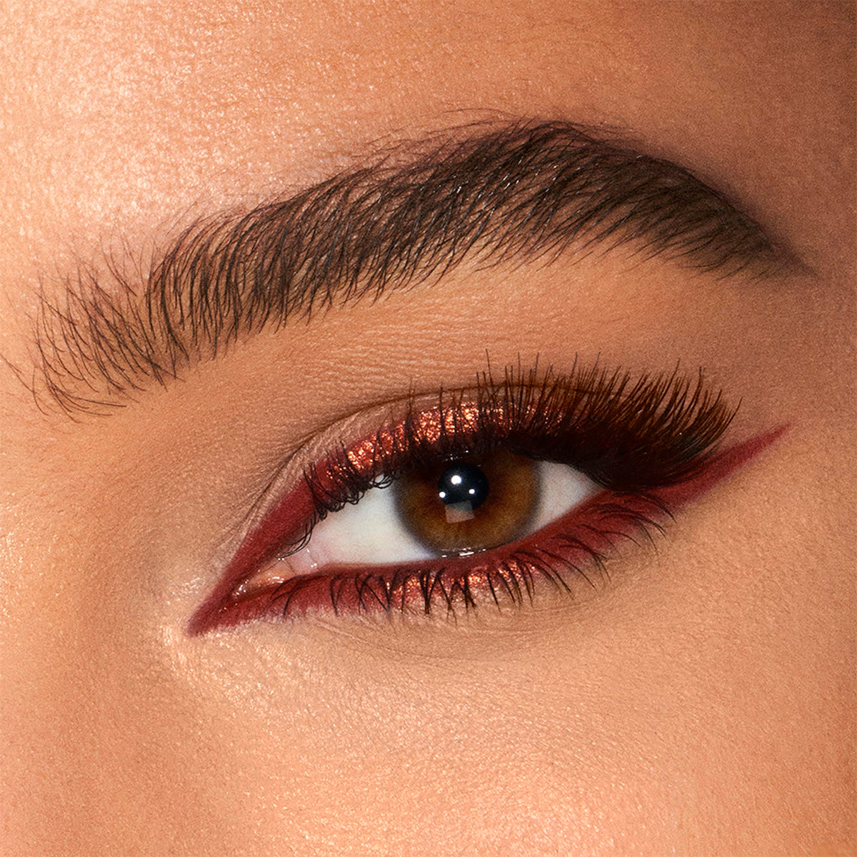 Charlotte Tilbury swatch of Copper Charge on skin demonstrating pigment and blendability
