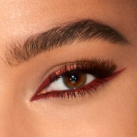 Charlotte Tilbury swatch of Copper Charge on skin demonstrating pigment and blendability