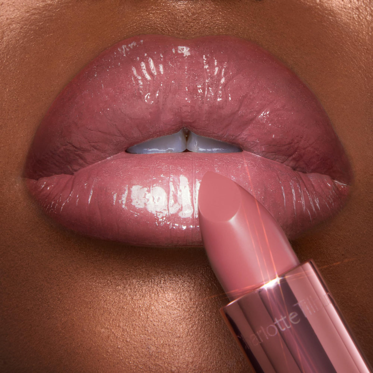 Charlotte Tilbury lipstick applied on model lips creating fuller look