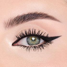 Model applying Charlotte Tilbury liner to inner corner to visibly open eyes