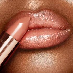 Charlotte Tilbury applying lipstick to lips demonstrating smooth finish