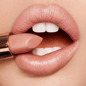 Charlotte Tilbury swatches on arm showing Penelope Pink buildable color
