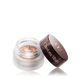 Charlotte Tilbury product in a makeup bag lifestyle scene showing travel-ready convenience