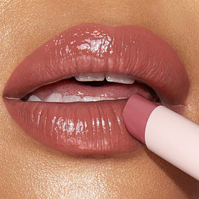 Charlotte Tilbury model applying Happikiss demonstrating hydrated, fuller-looking lips