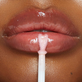 Charlotte Tilbury lifestyle shot of model wearing Collagen Lip Bath for a fuller-looking, glossy pout
