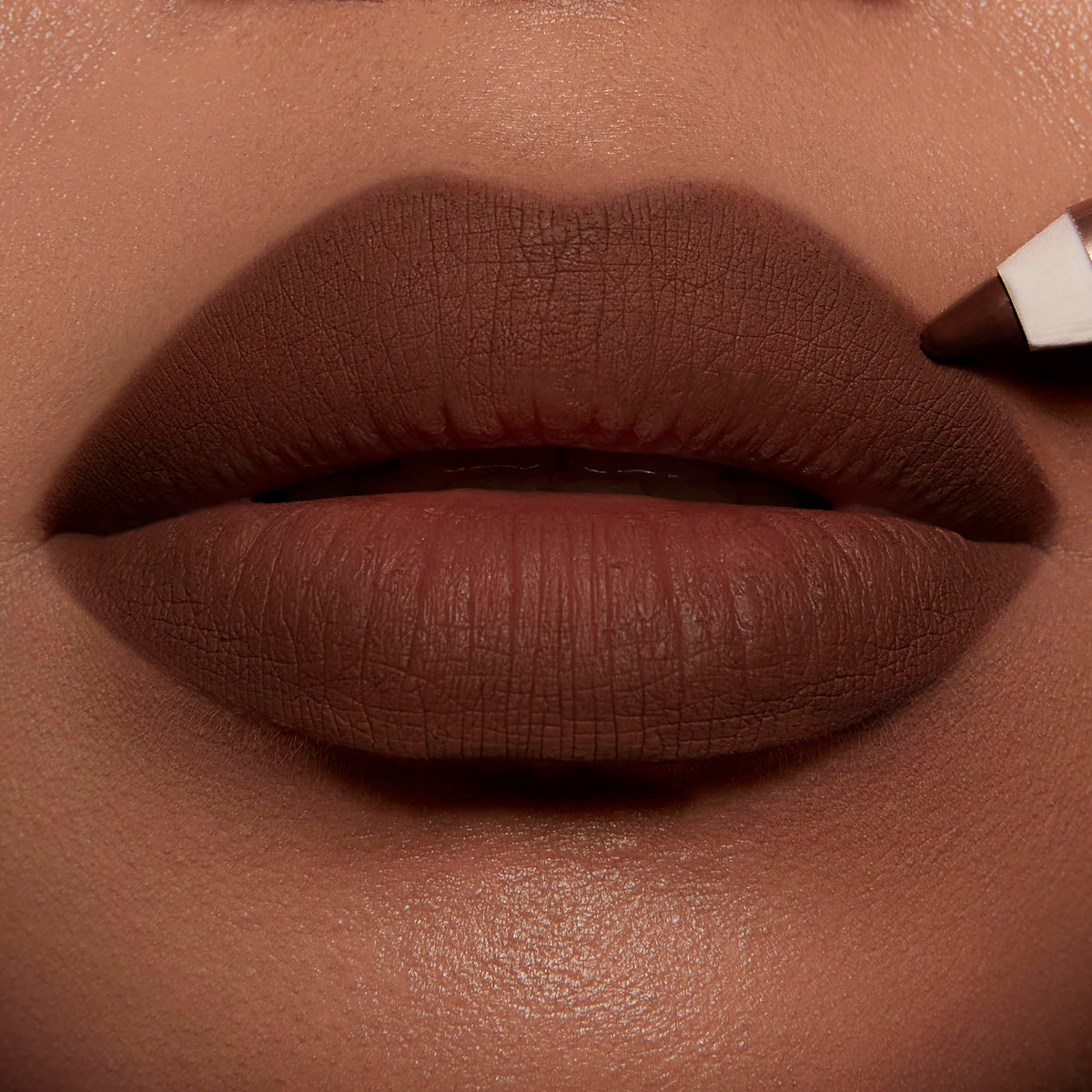 Charlotte Tilbury liner held in hand to show true size and portability