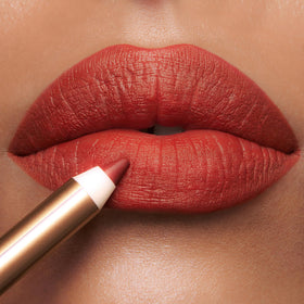Charlotte Tilbury lip pencil held in hand to show real-life size and scale