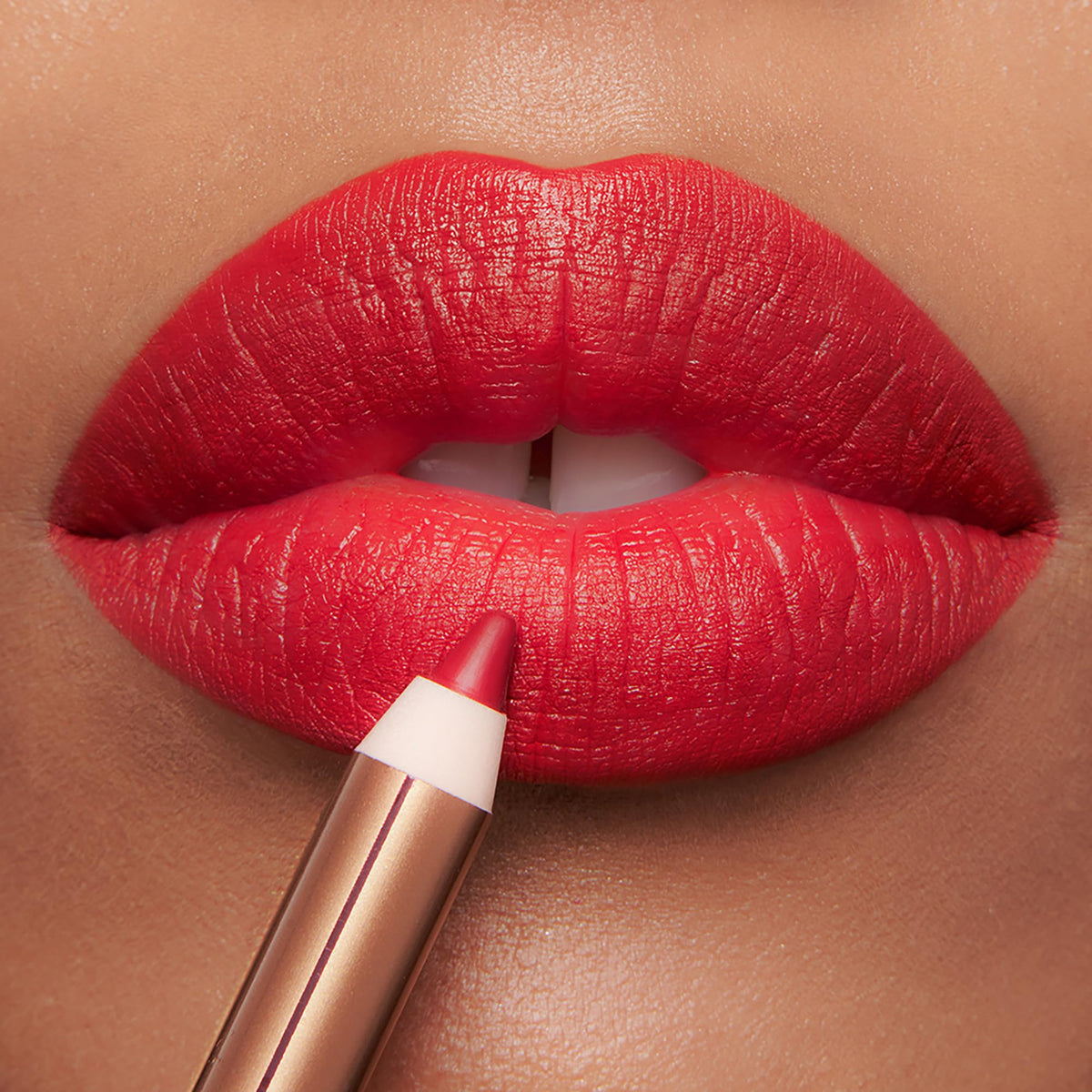 Charlotte Tilbury close-up of lips wearing liner showing defined, fuller-looking pout