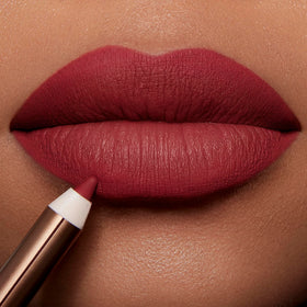 Charlotte Tilbury on-lips application of Savage Rose showing defined fuller pout