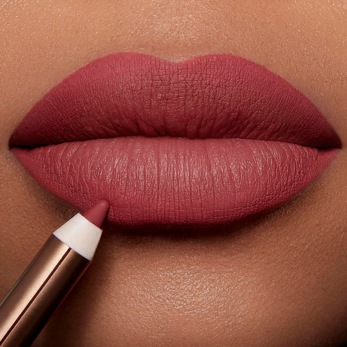 Charlotte Tilbury lip liner applied on lips demonstrating natural rose-pink definition