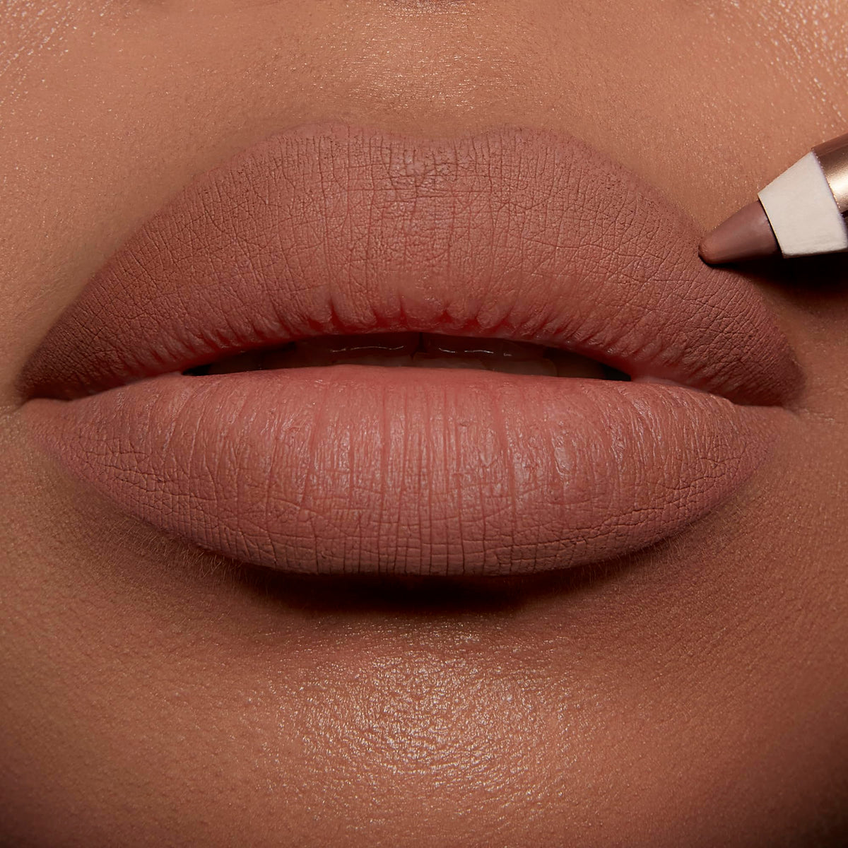 Charlotte Tilbury lip liner applied on model demonstrating reshaped fuller-looking lips