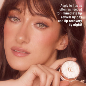Charlotte Tilbury hand swatch of product, demonstrates sheer glossy coverage