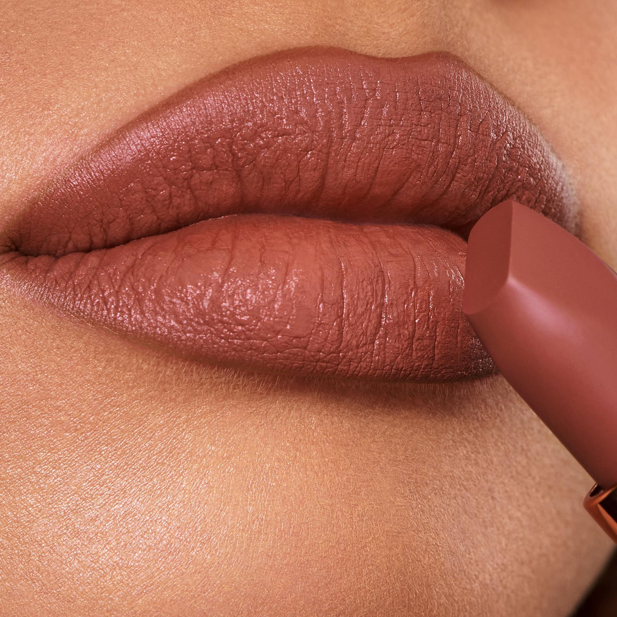 Charlotte Tilbury lip swatch on model showing Super Fabulous color confidence
