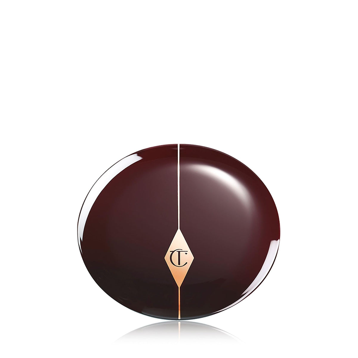 Charlotte Tilbury compact next to coin size comparison showing portable, purse-friendly design