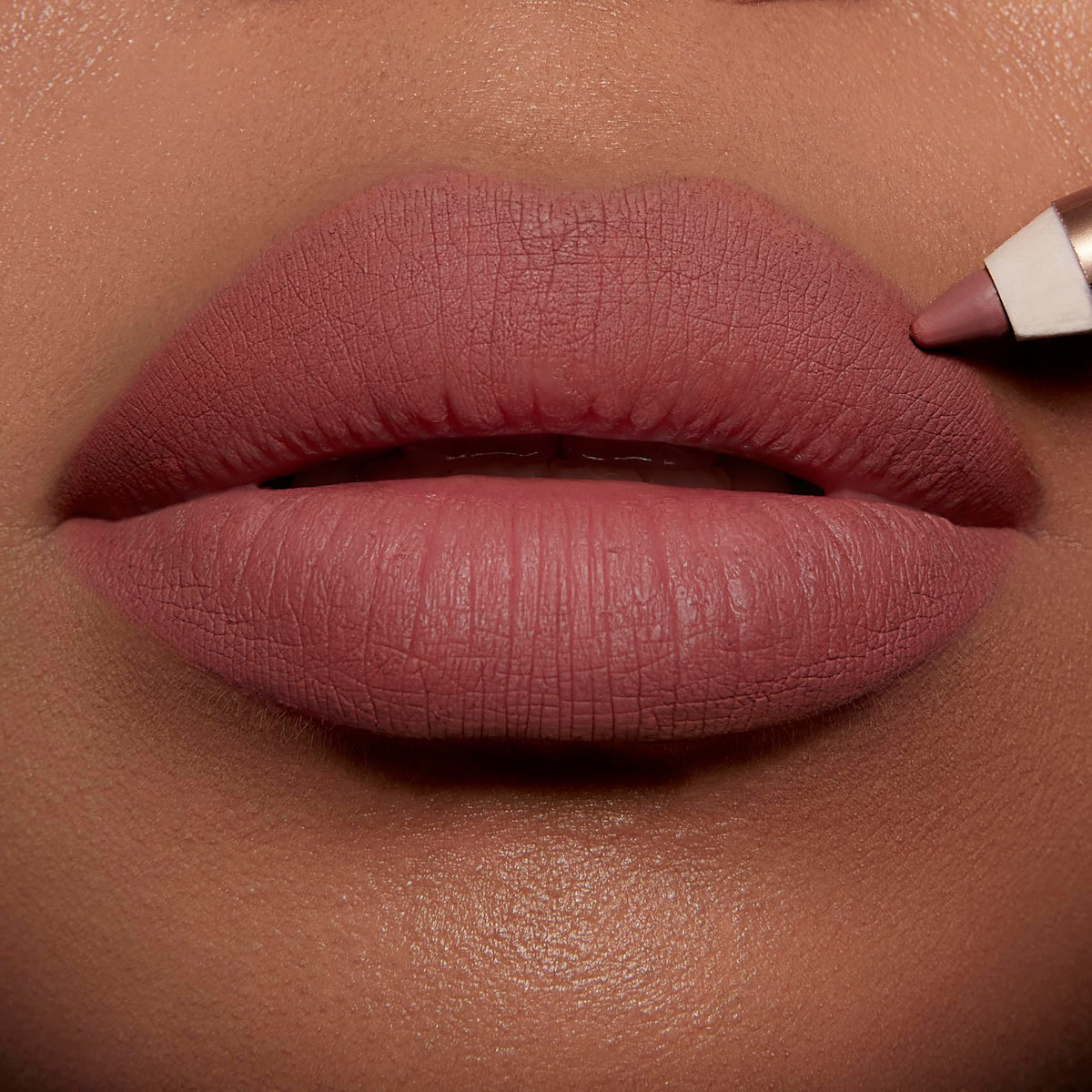 Charlotte Tilbury pencil held in hand showing scale and portability benefit