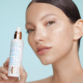 Charlotte Tilbury fine mist visible in air delivering quick-refresh hydration