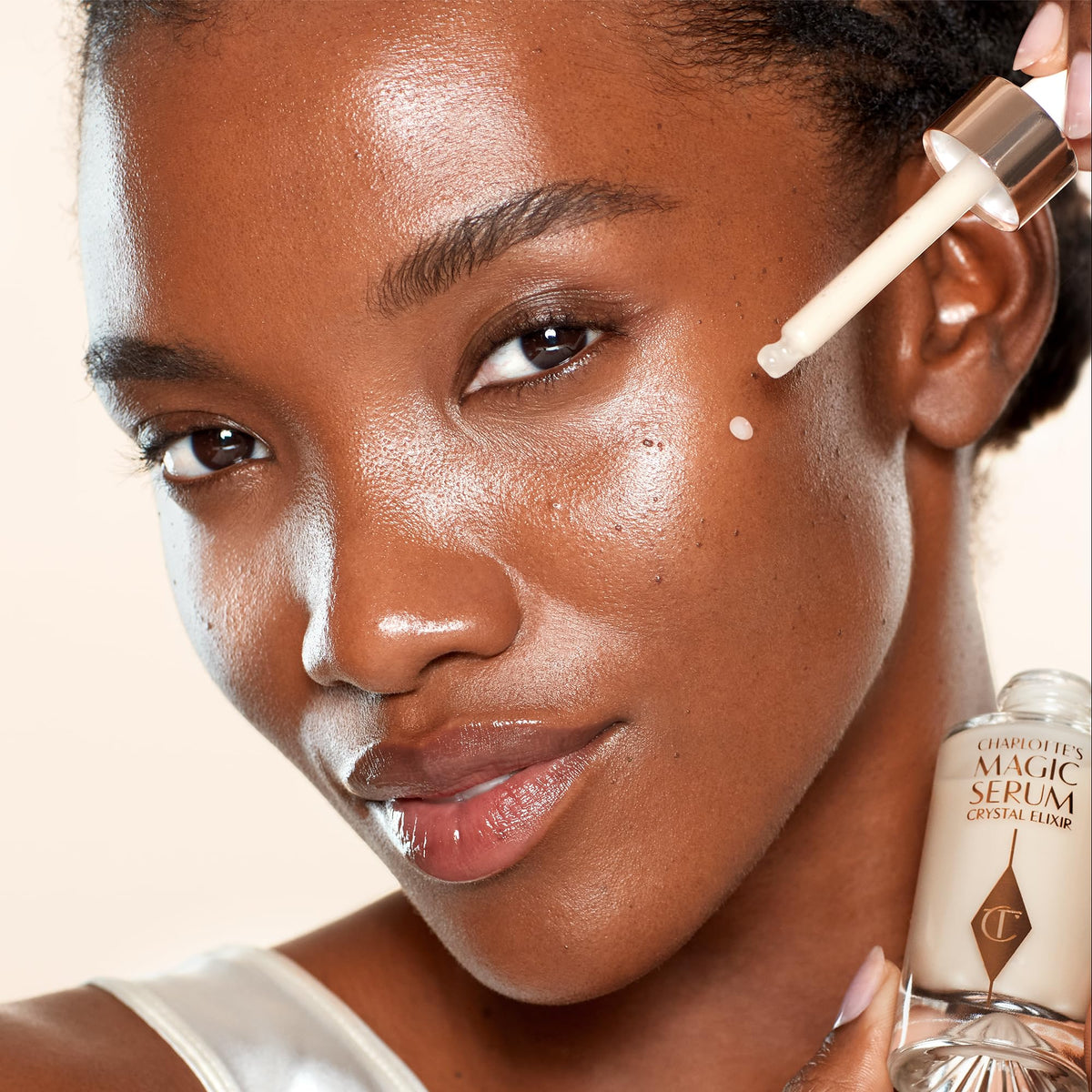 Charlotte Tilbury application on hand demonstrating blendability and fast absorption for hydrated, plump-looking skin benefit